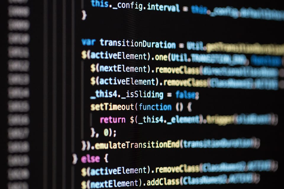 Code on a dark screen, close up